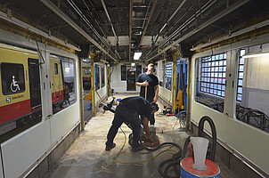 S-Bahn-Arbeiter schleifen den Boden einer renovierten 481 im Werk Schöneweide