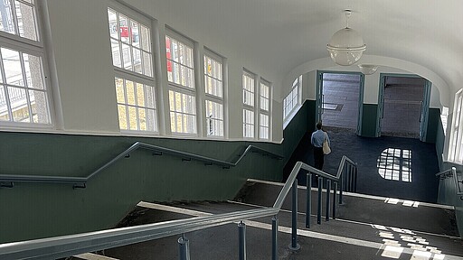 Ikonische Kugellampen, Sprossenfenster und alte Geländer sorgen für historisches Flair im Bahnhofsgebäude.