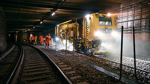 Die Stopfmaschine drückt den Schotter unter die Holzschwellen, um die Gleise wieder auf die vorgeschriebene Höhe zu bringen.