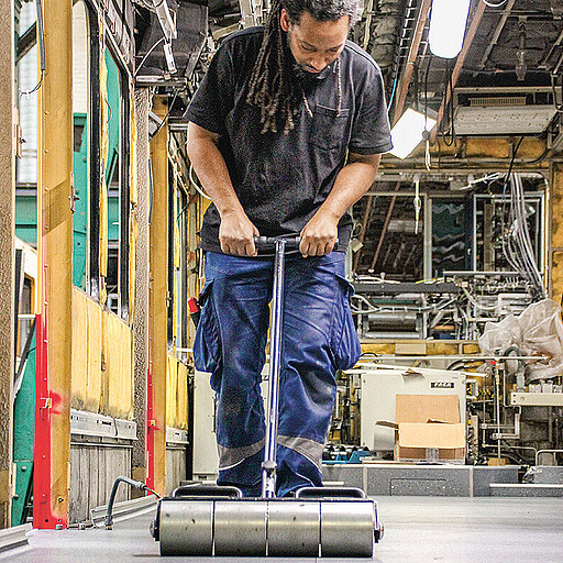 Rollen bis zur Planlage Die Teilstücke aus Linoleum werden in Planlage gebracht.