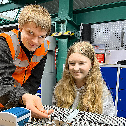 Handwerkliches Geschick erproben Azubi Fridolin Sohr zeigt Schülerin Ida wie Ösen mit einer Rundzange gebogen werden.