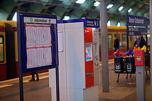 Ticket machines which provide fare information are located next to showcases that display updated train schedules.